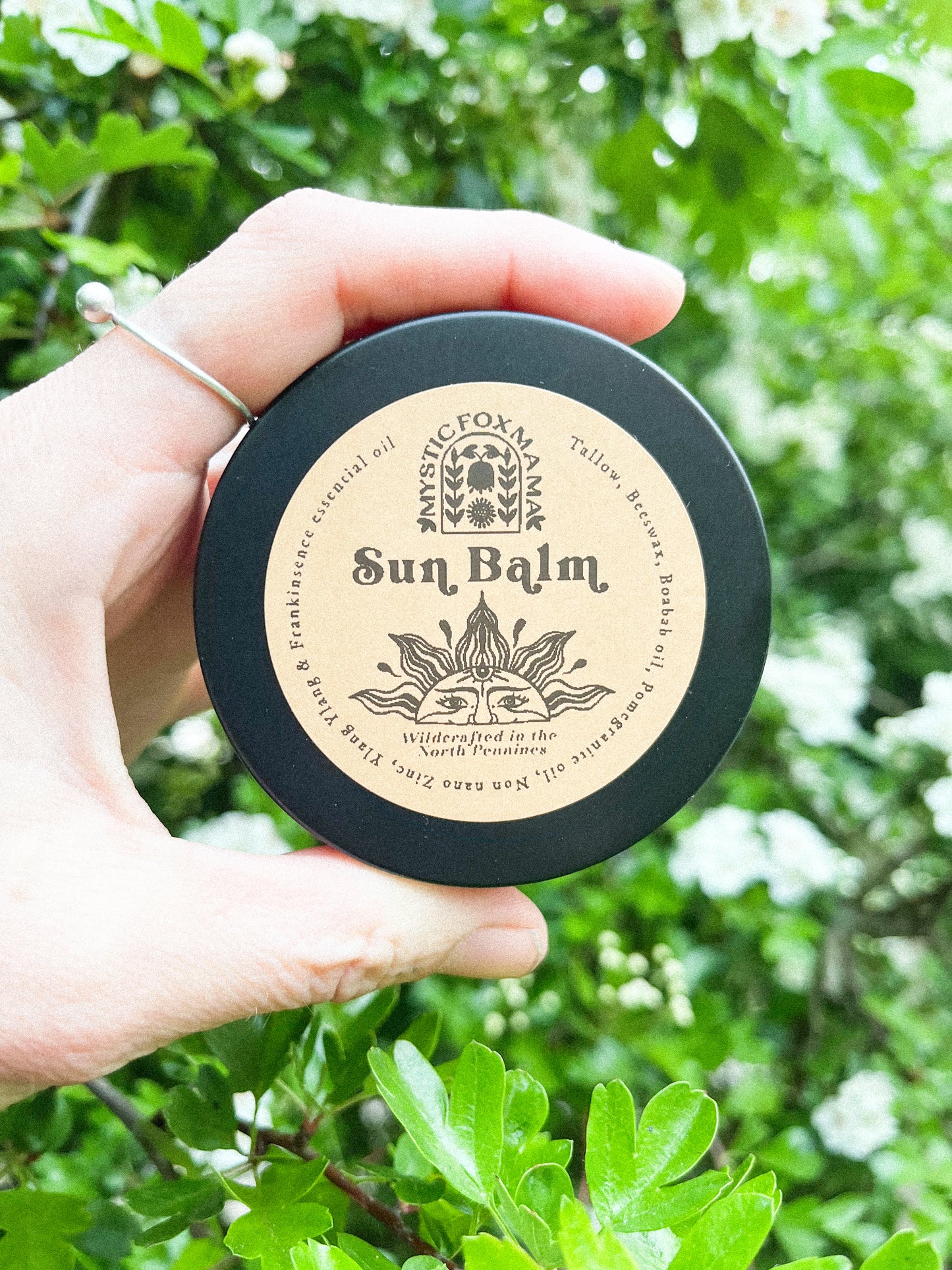 Glass jar of Tallow and zinc sunscreen outside with label on 